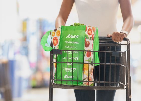 Customer with a cart and Sobeys reusable bag shopping