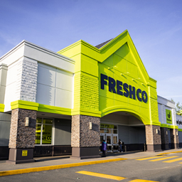 Une image d'un bâtiment vert et blanc avec le logo de la marque Frescho.