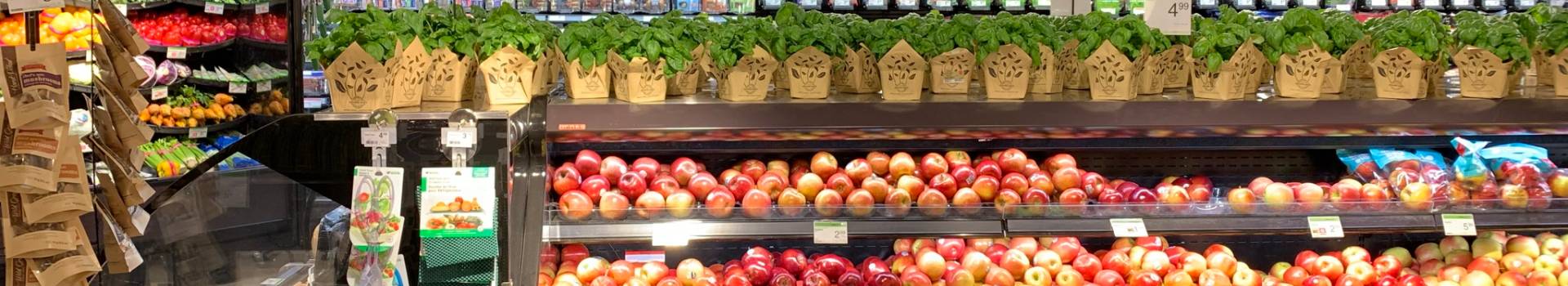 An image showing fresh apples and Plants in the grocery store