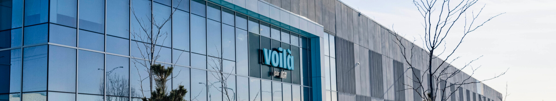 An image showing the building with Voila branding logo in the centre