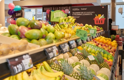 In this image, fresh vegetables and fruit are displayed in a store with price tags.